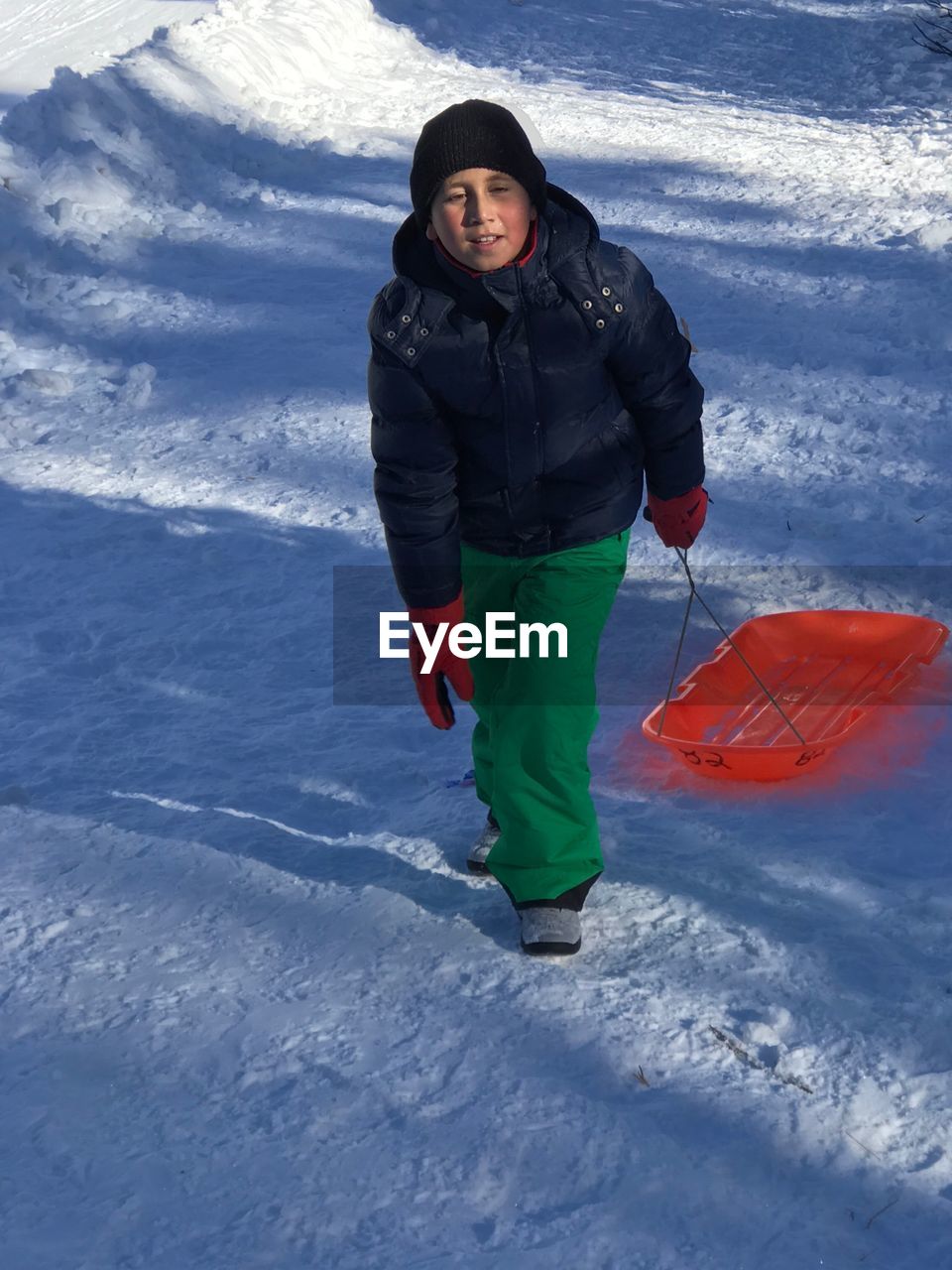 Portrait of boy walking on snow