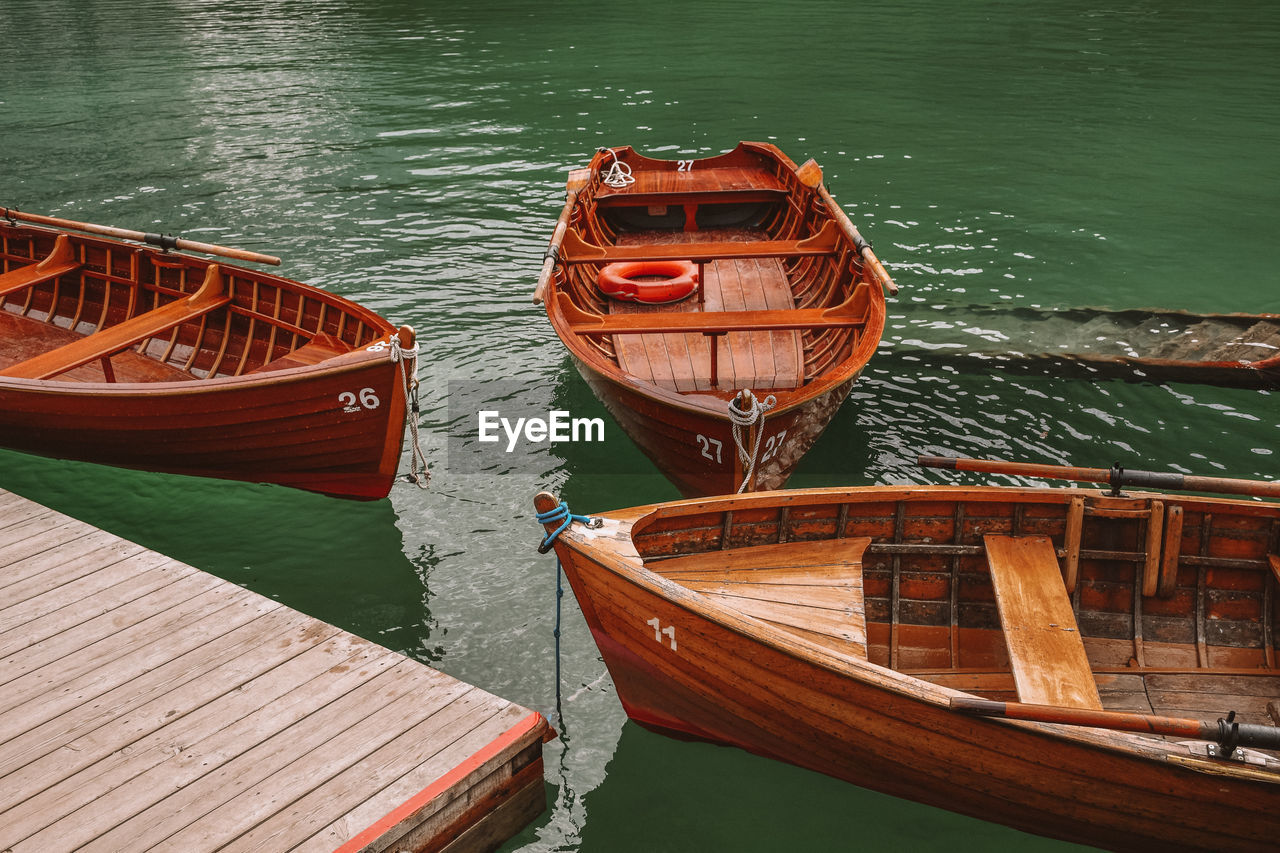 Boats moored at pier on lake