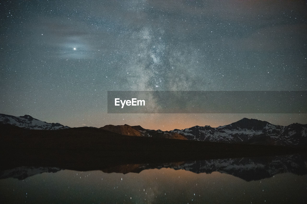 Scenic view of lake against sky at night. view on the milky way.