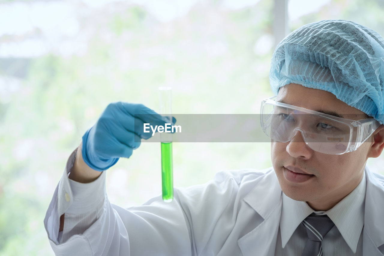 Scientist analyzing test tube at laboratory