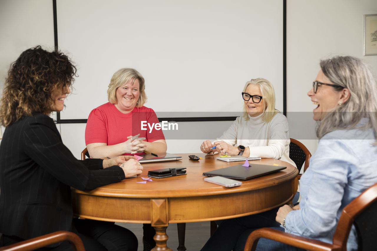 Mature businesswomen sitting at table during business meeting