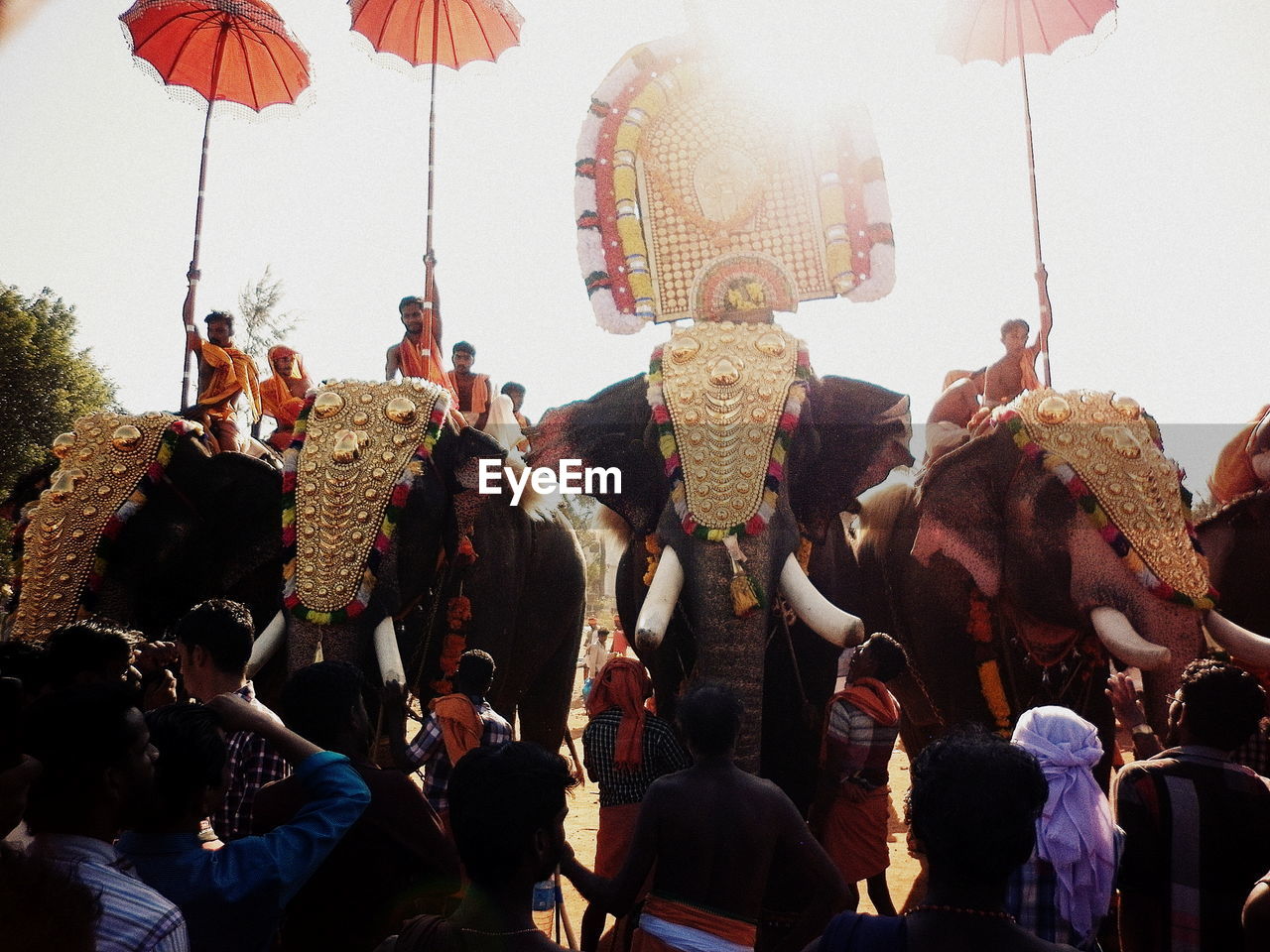 Group of people in traditional clothing against sky