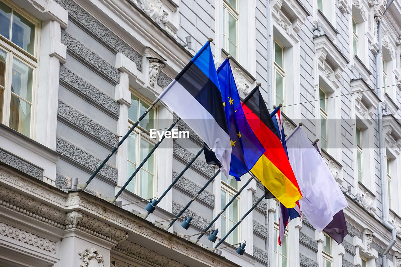 LOW ANGLE VIEW OF FLAGS AGAINST BUILDING