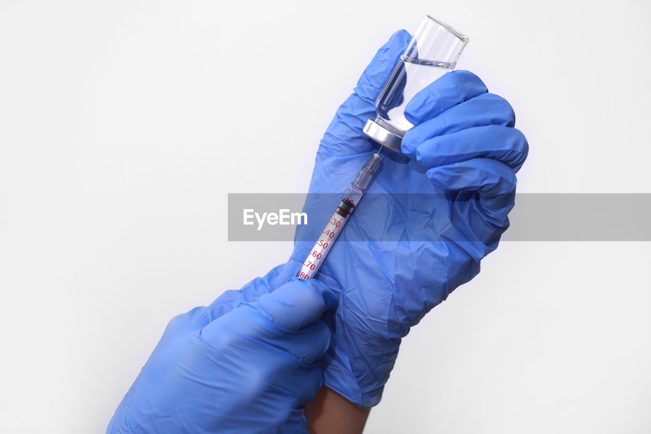 Medical hand gloves dispose medication drug needle syringe drug,concept flu shot vaccine vial dose 