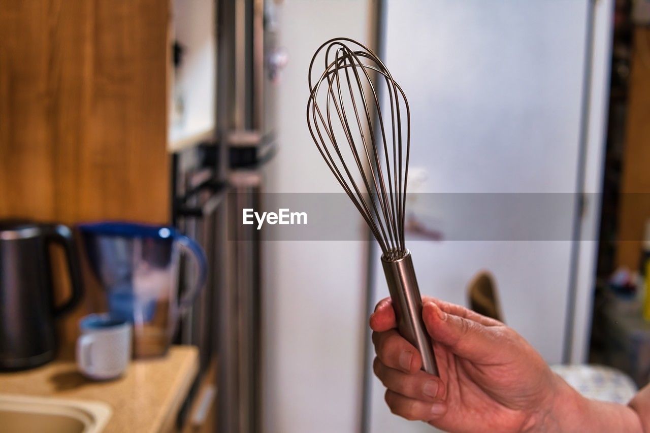 hand, one person, indoors, kitchen utensil, kitchen, adult, holding, domestic room, domestic kitchen, focus on foreground, home, room, lifestyles, household equipment, domestic life, close-up, food and drink, home interior, tableware, selective focus