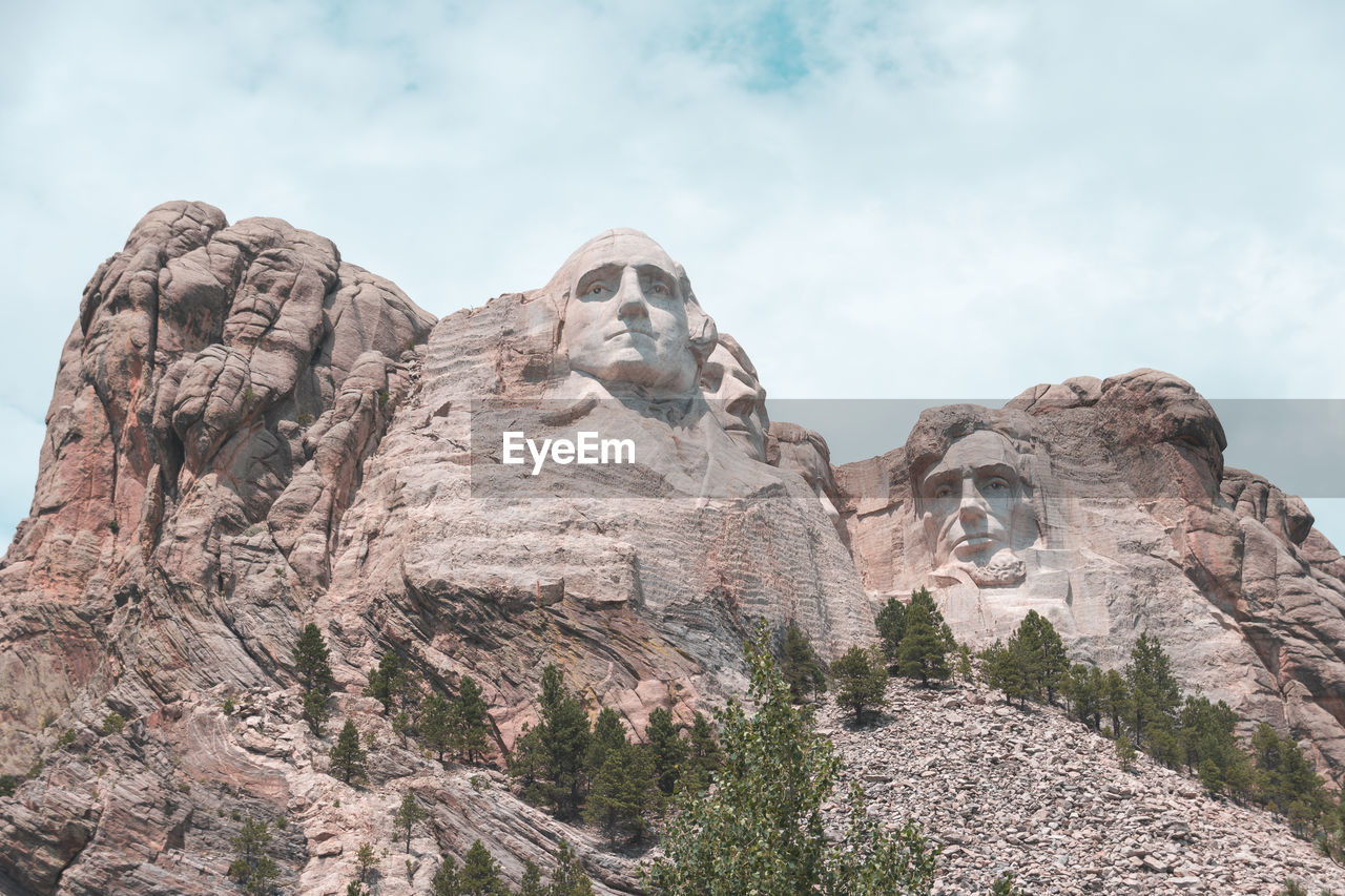 LOW ANGLE VIEW OF STATUE ON ROCK FORMATION