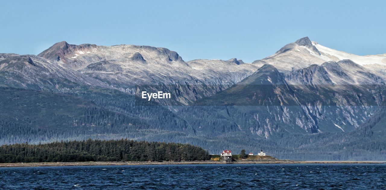 Scenic view of snowcapped mountains by lake against sky