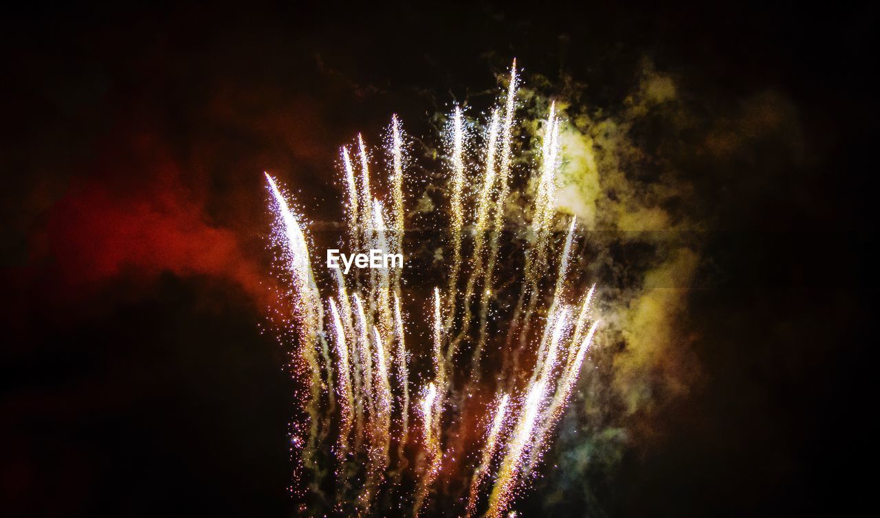 Low angle view of illuminated firework display in sky