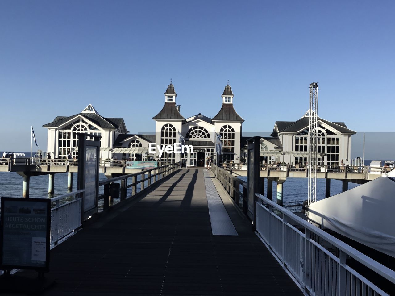 Buildings on pier against clear blue sky