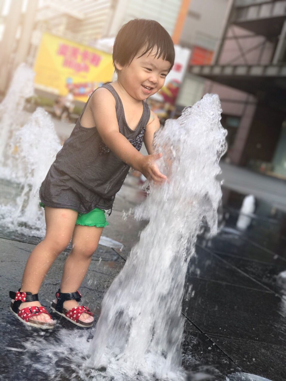 FULL LENGTH OF HAPPY BOY WITH WATER