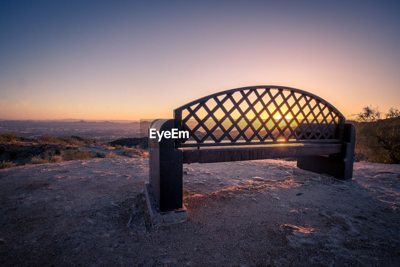 A bench overlooks the sunrise in phoenix, arizona.
