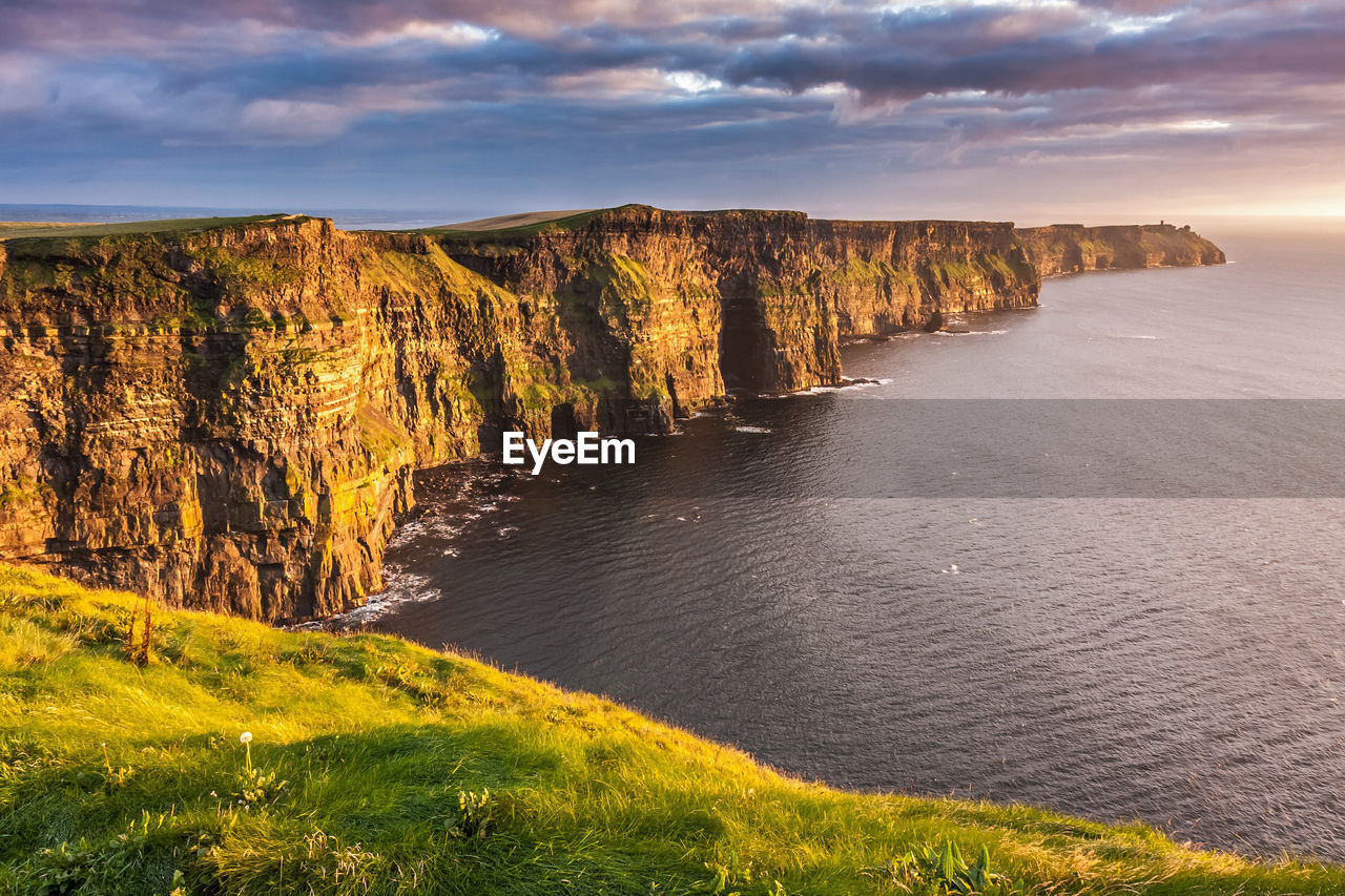 The majestic cliffs of moher in ireland at sunset.