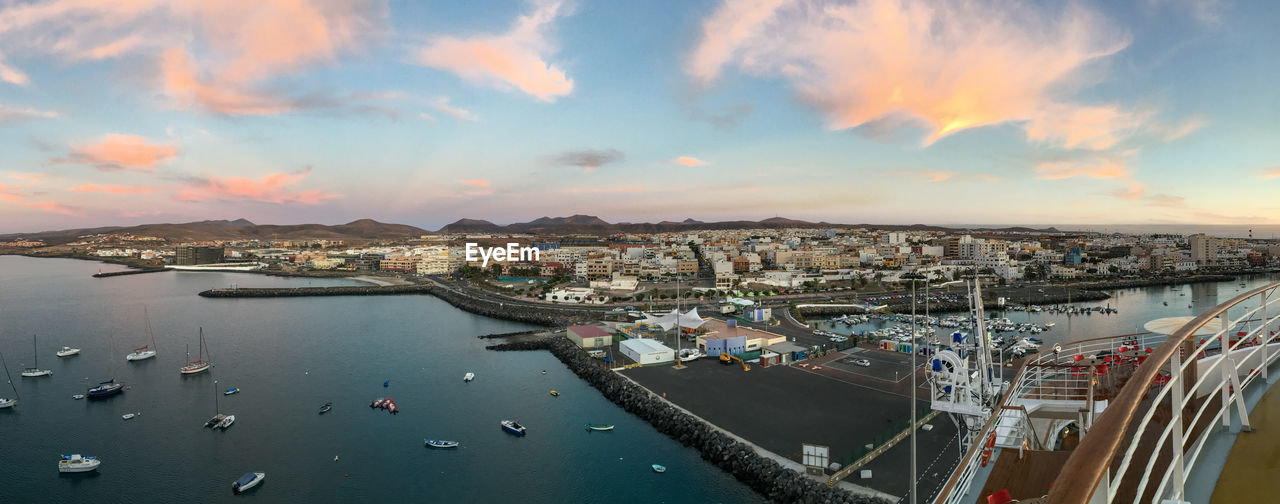 Aerial view of cityscape against sky during sunset