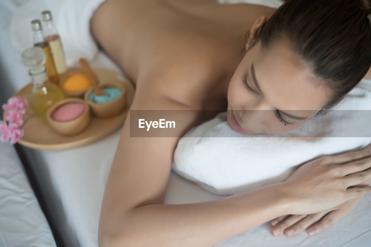 Young woman lying on massage table