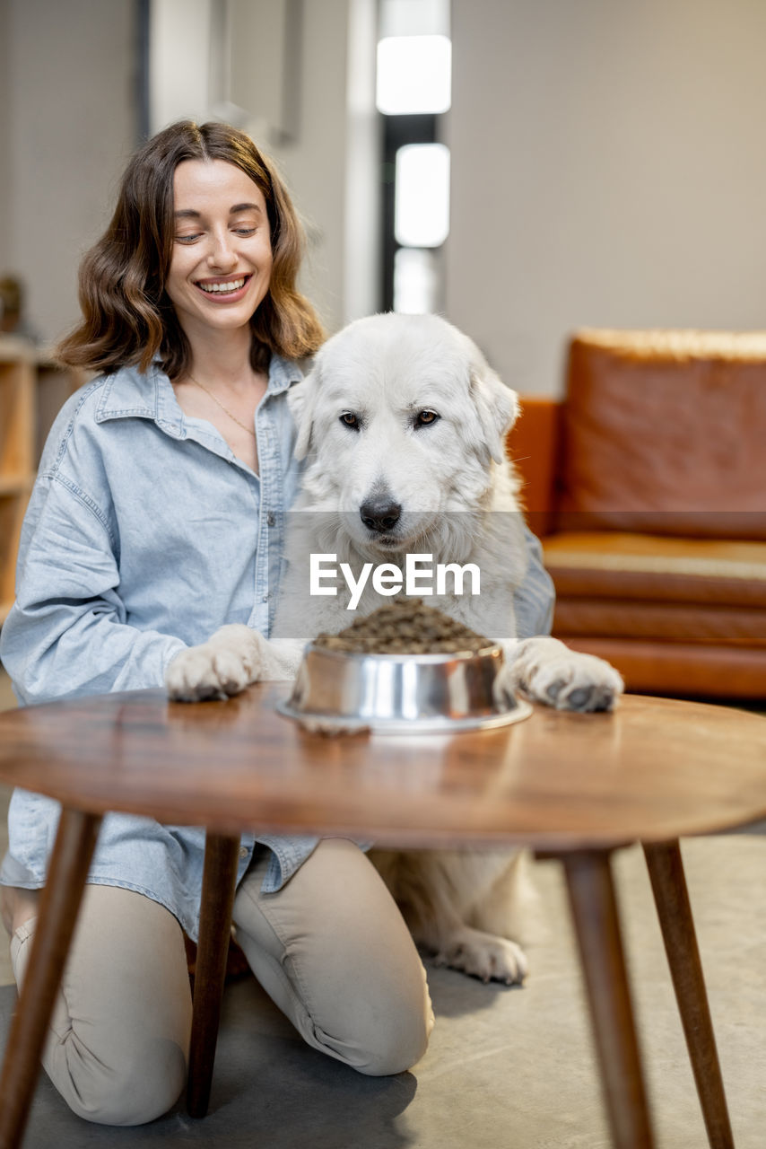 Portrait of smiling young woman with dog