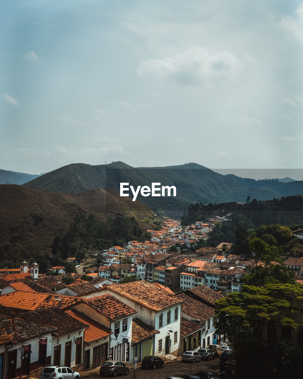 Town by mountains against sky