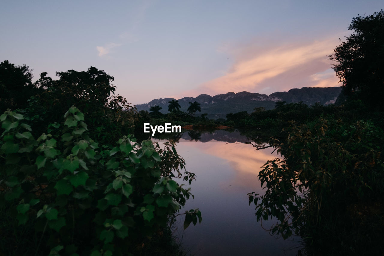 Scenic view of lake against sky during sunset