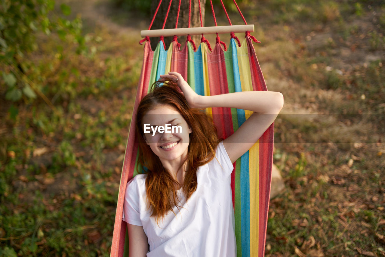 Smiling woman sitting in hammock