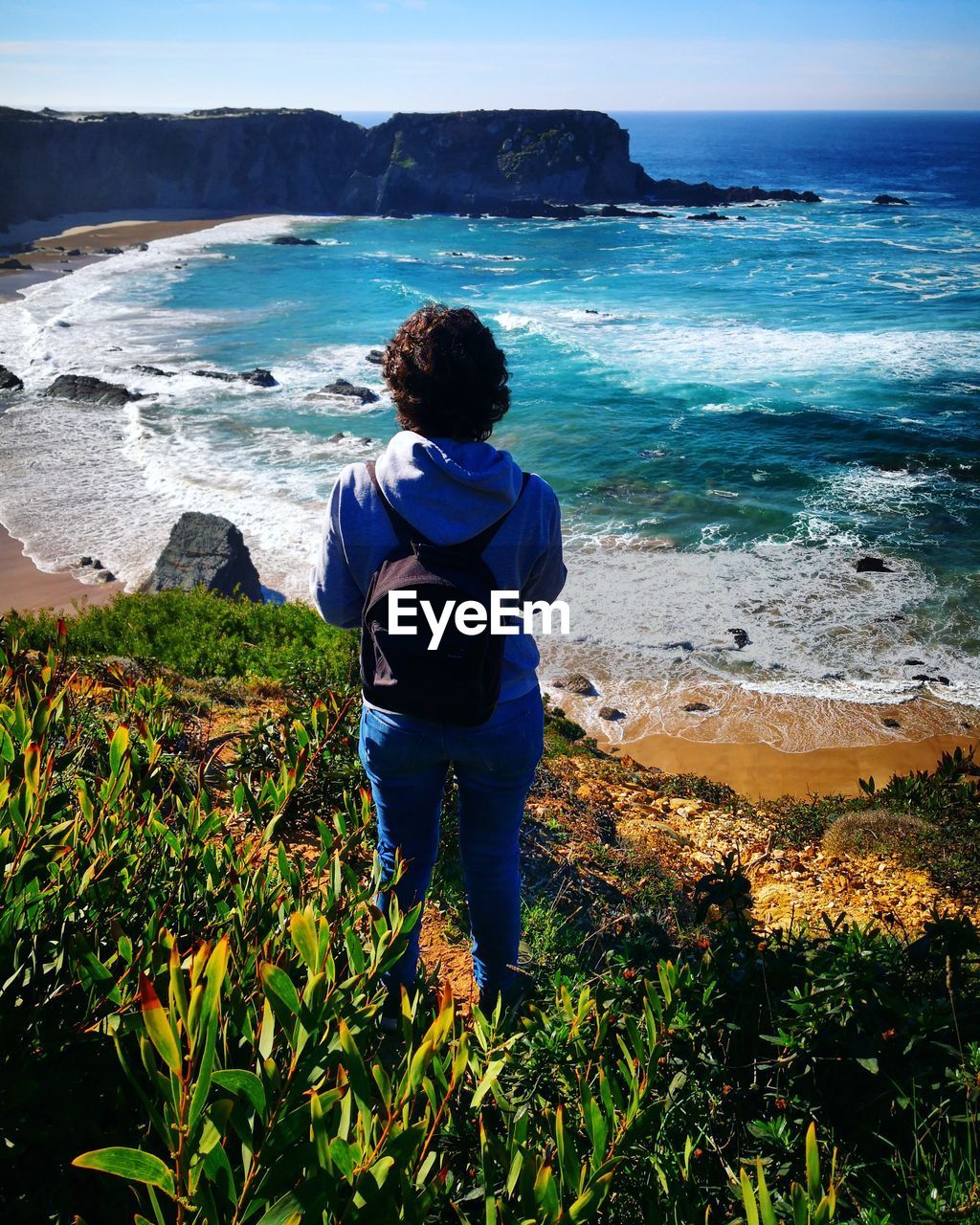 Rear view of man standing on beach