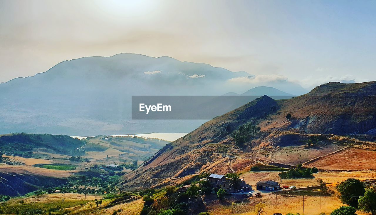 AERIAL VIEW OF MOUNTAINS AGAINST SKY