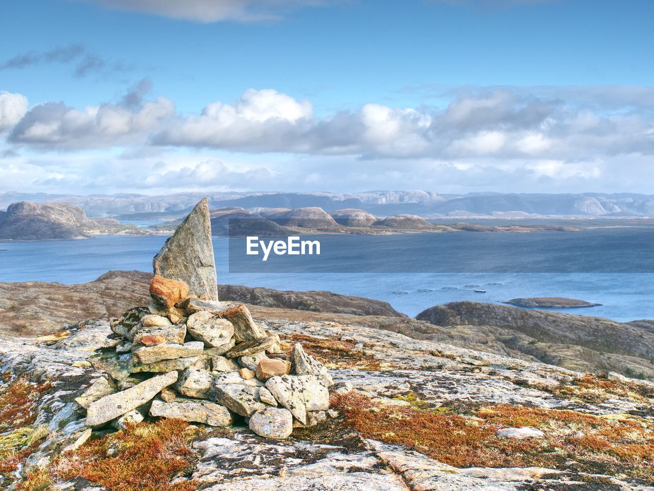 Pebbles pyramid at mountain peak linesfjellet,  linesøya island, norway. stones on mountain peak