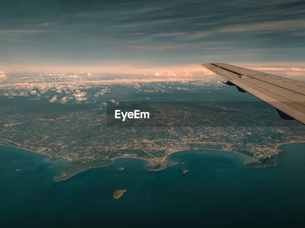 Aerial view of sea against sky during sunset