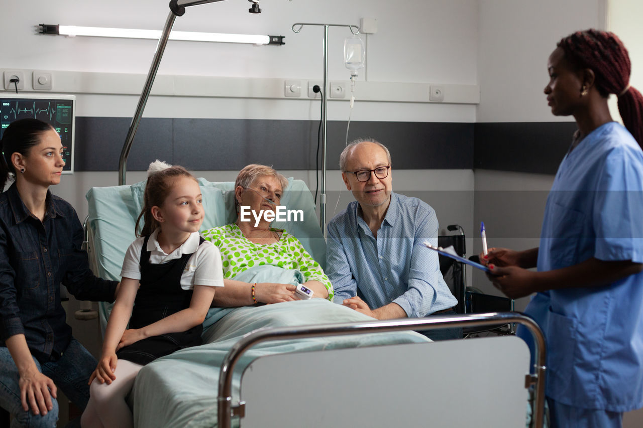 Doctor talking with patient and family