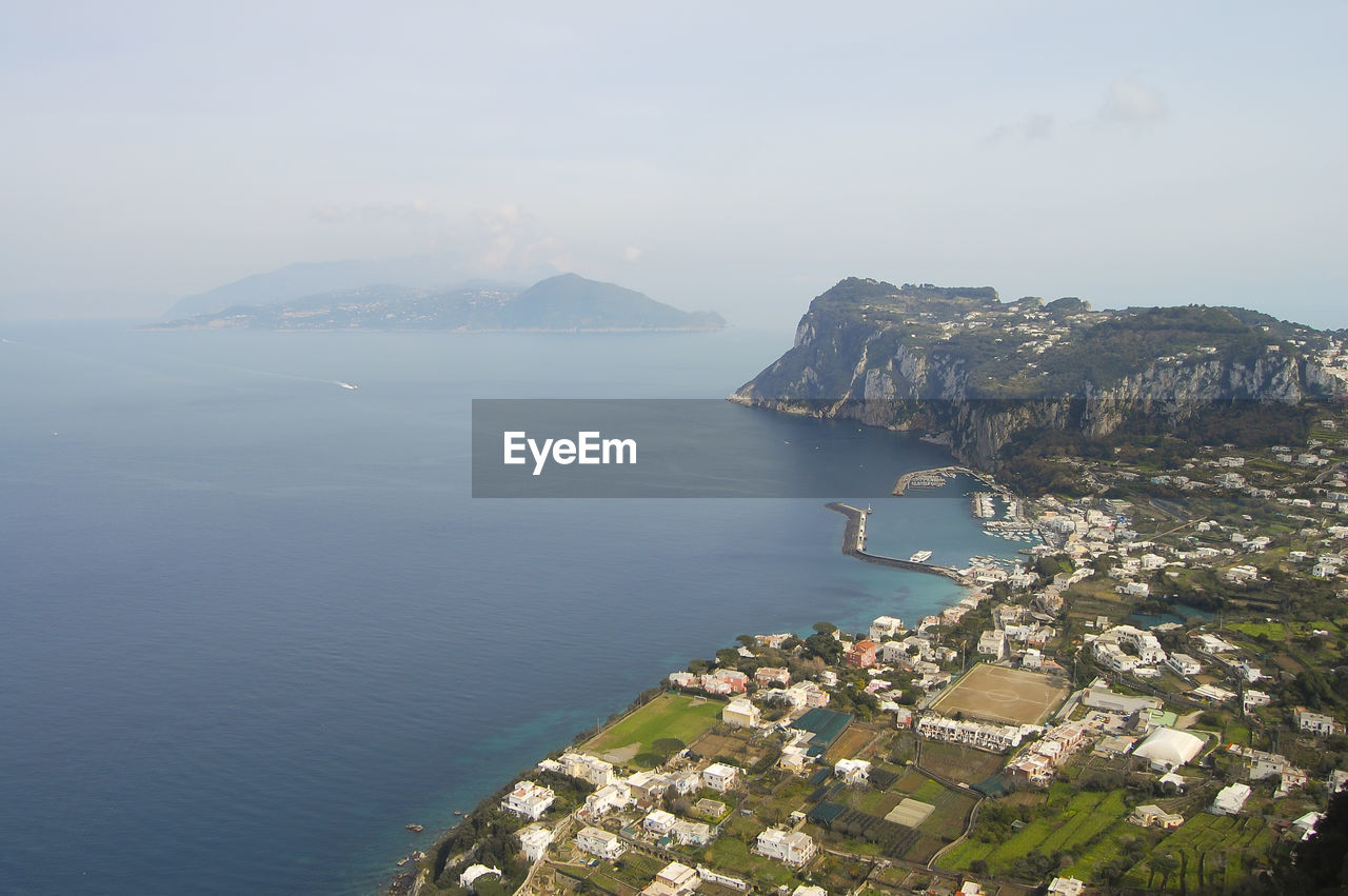 Scenic view of sea and mountains against clear sky