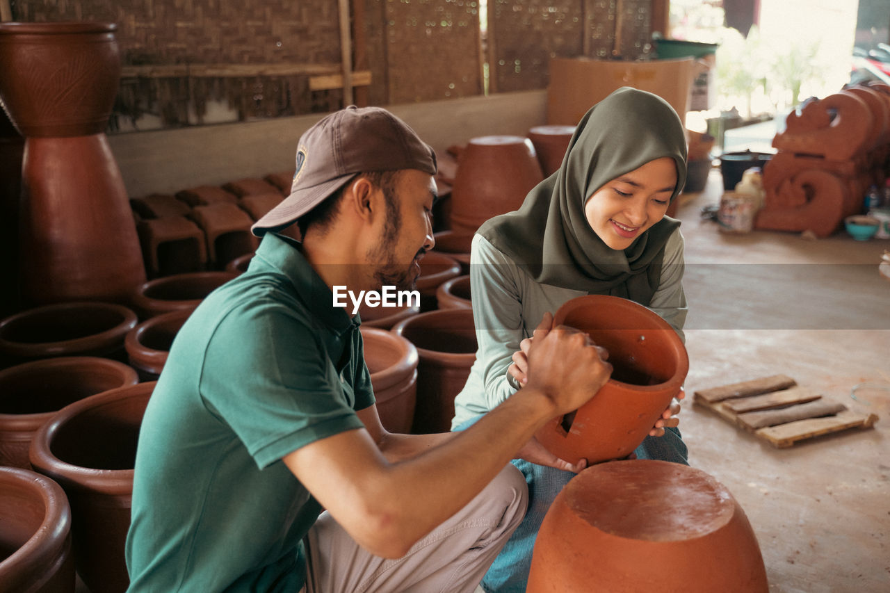 side view of young man working at workshop