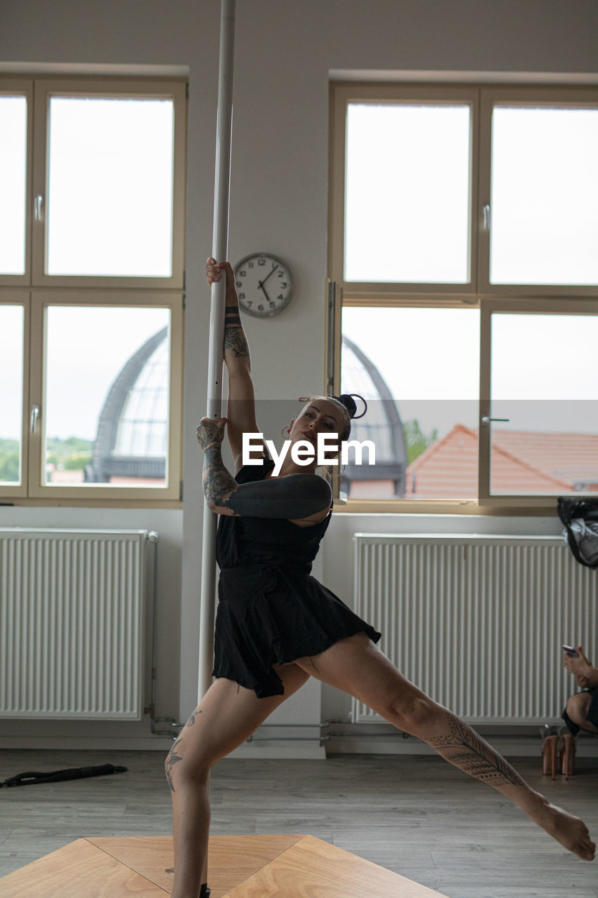 side view of young woman exercising at home