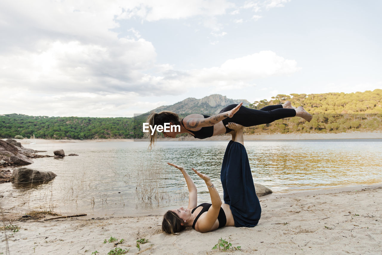 Young female friends doing acroyoga