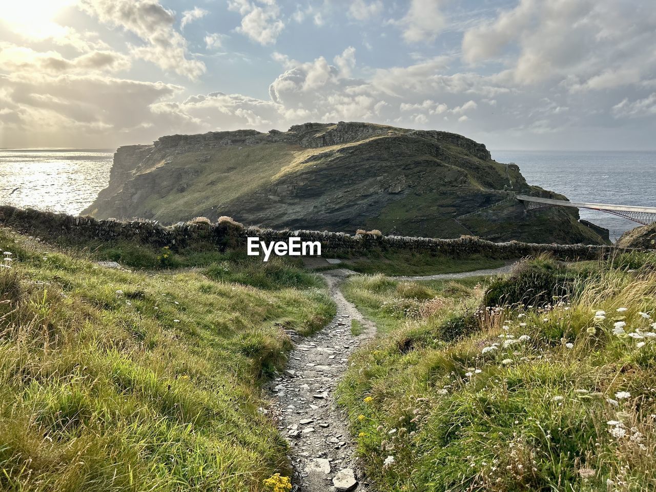 scenic view of sea and mountains against sky