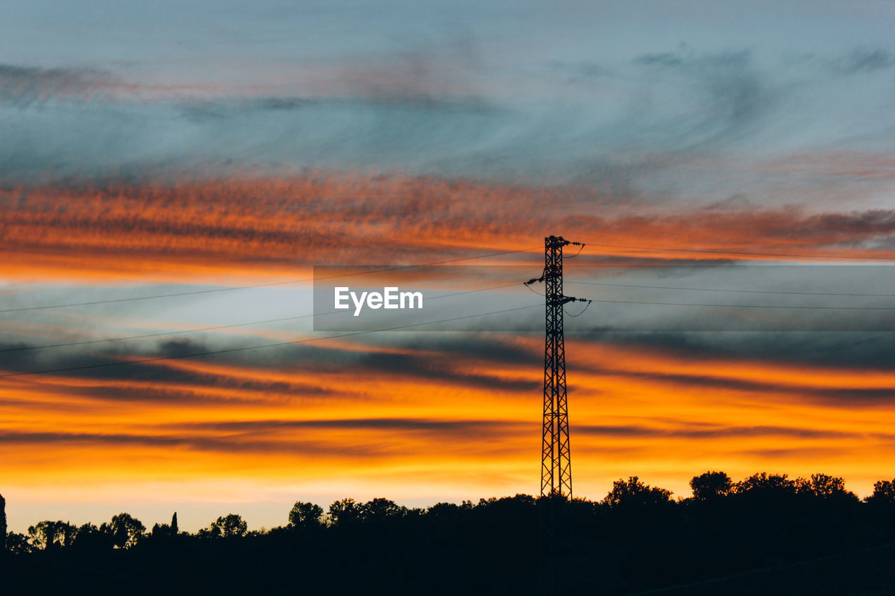 SILHOUETTE OF ELECTRICITY PYLON AGAINST SKY DURING SUNSET