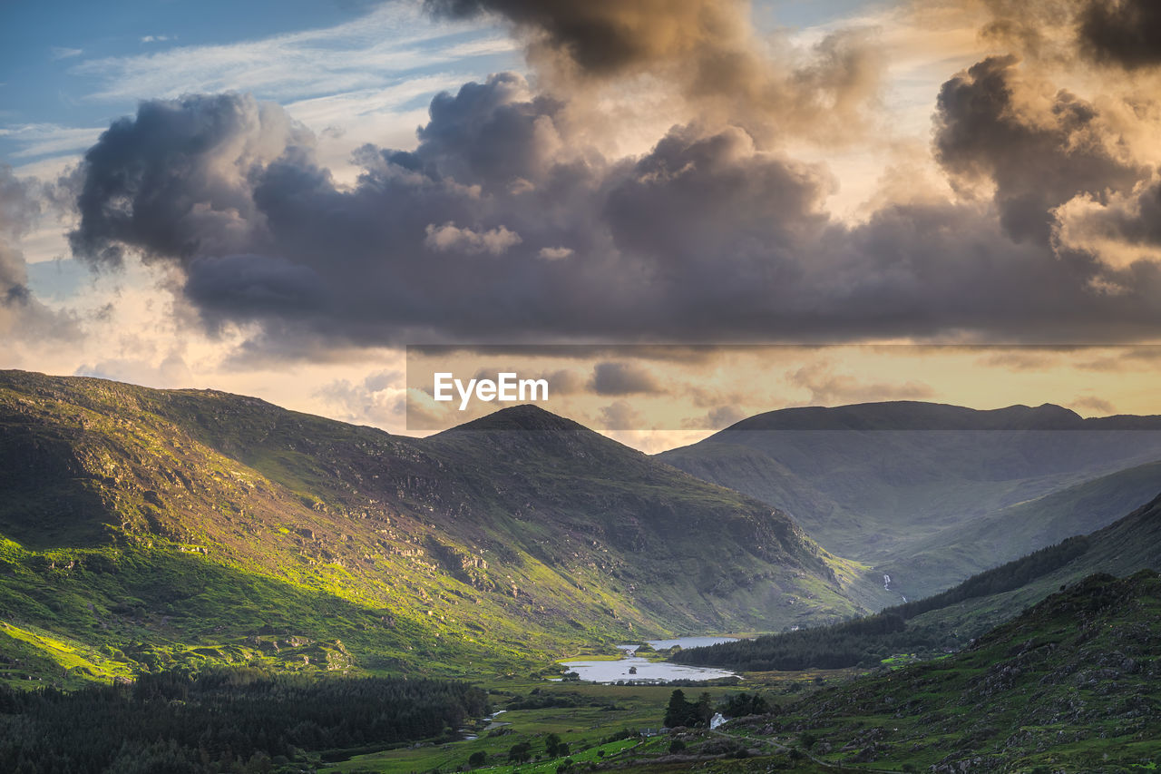 SCENIC VIEW OF MOUNTAINS AGAINST SKY DURING SUNSET