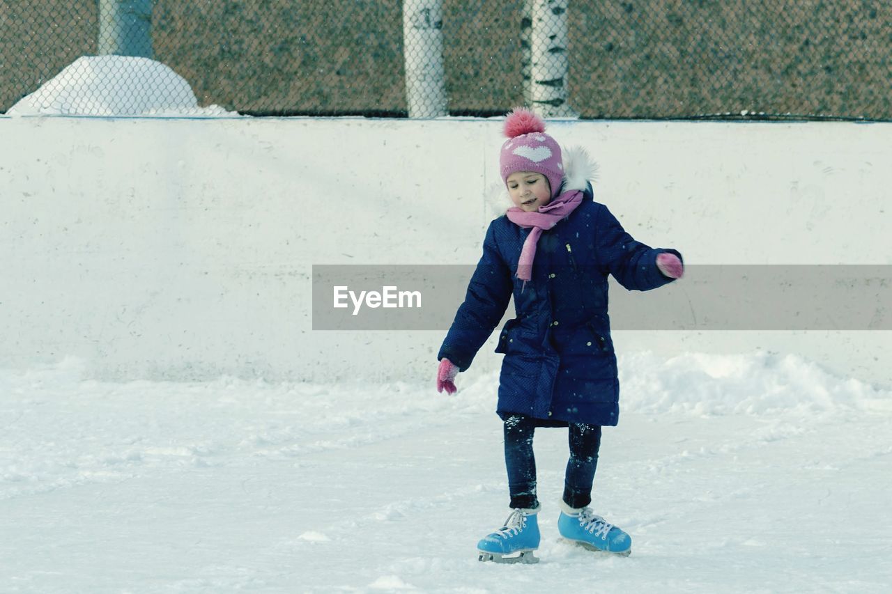 Full length of cute girl standing in ice