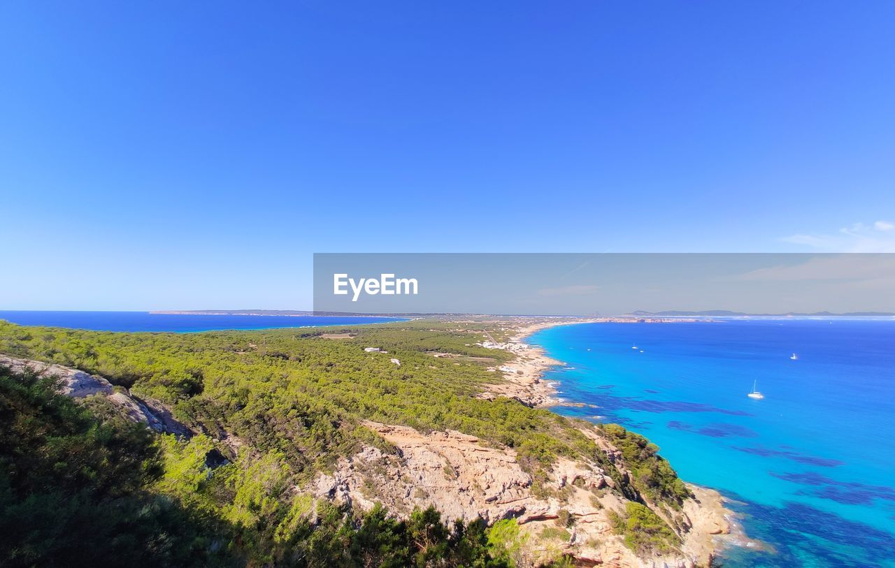 Scenic view of sea against clear blue sky