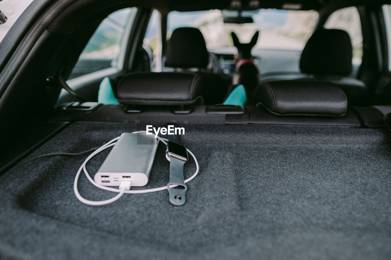 View of charger and smartwatch on car trunk