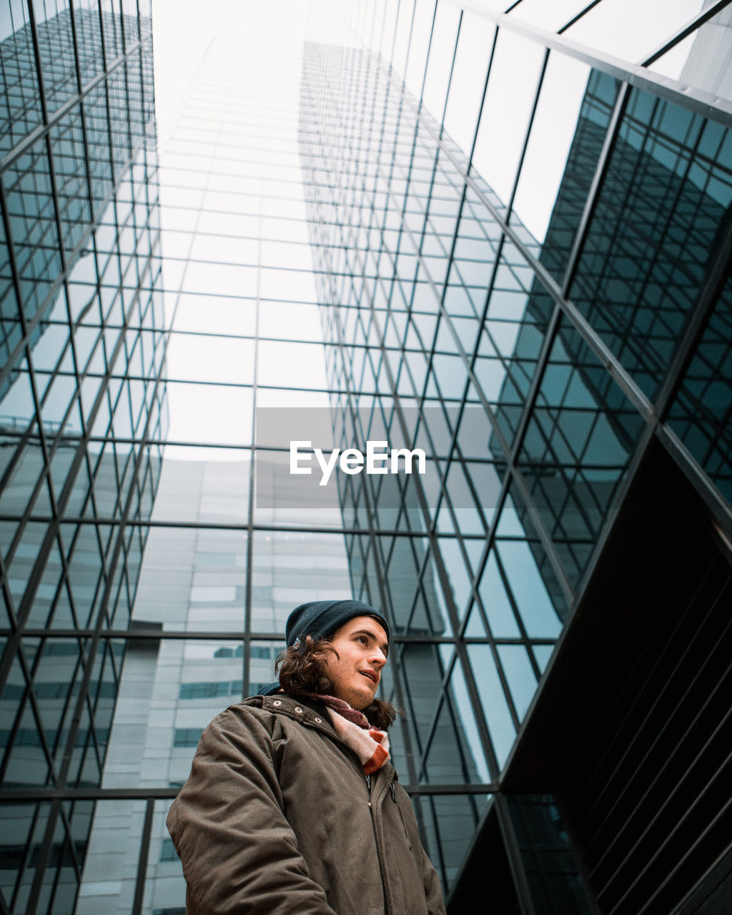 Low angle view of man against skyscraper in city