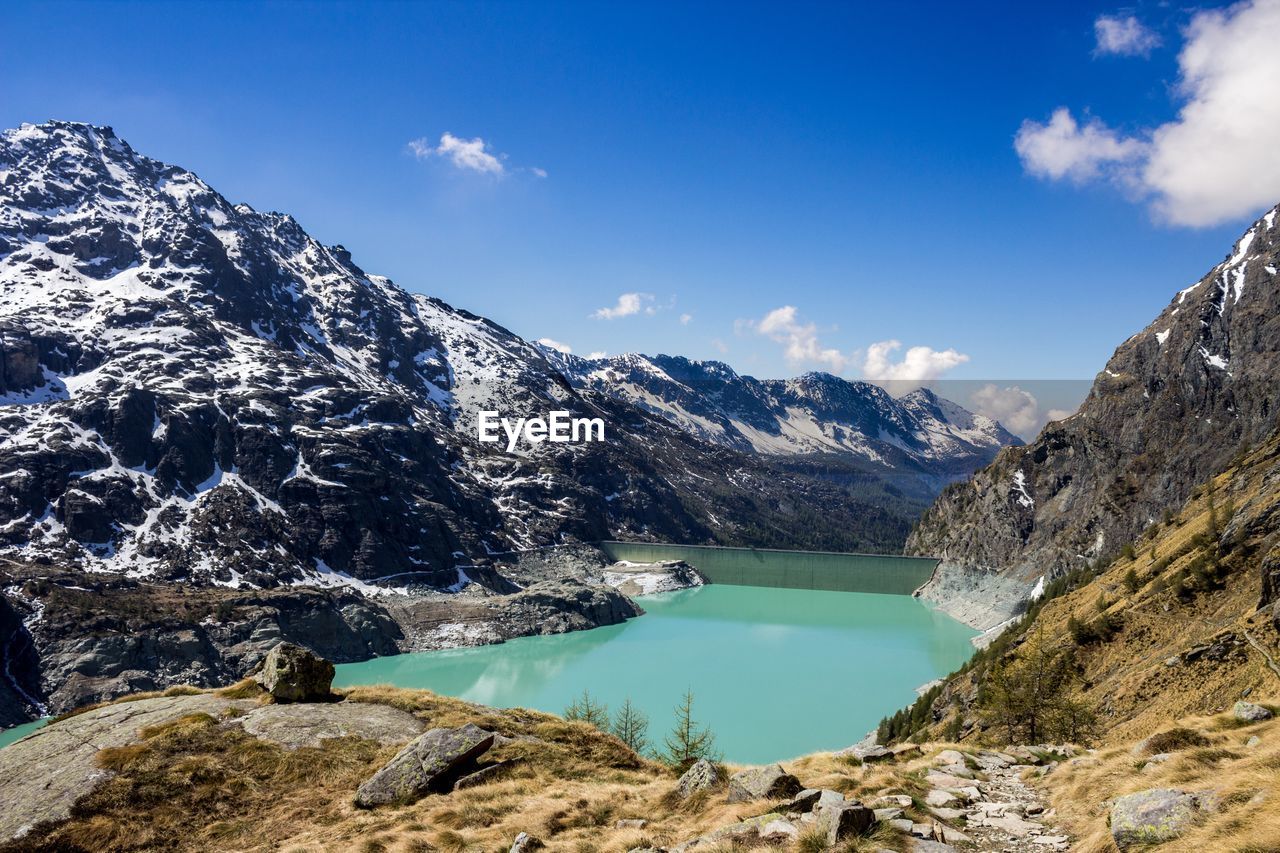 Scenic view of lake and snowcapped mountains against sky