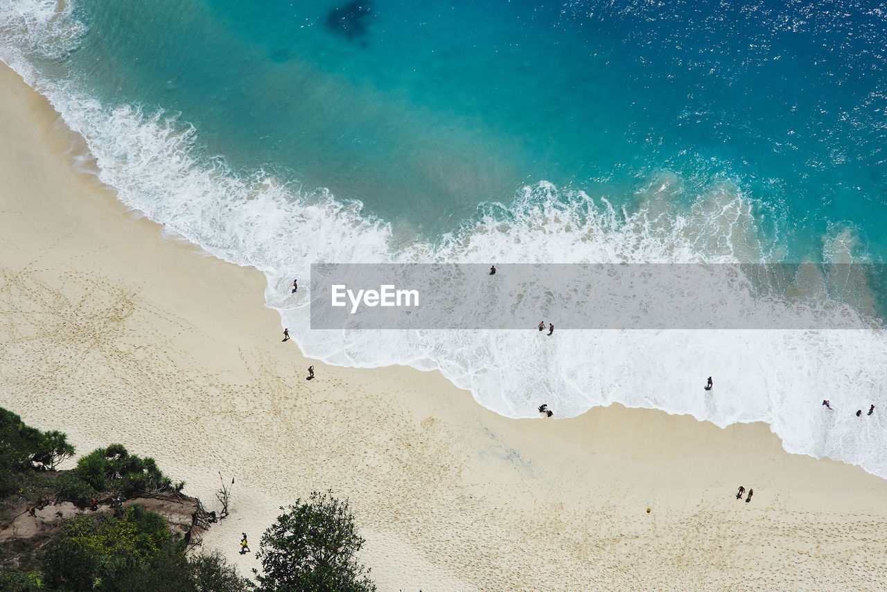 High angle view of beach and sea with tourists