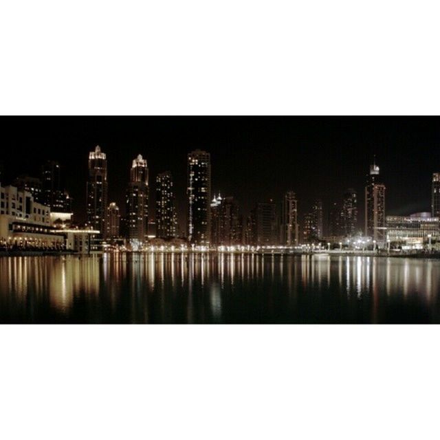 REFLECTION OF ILLUMINATED BUILDINGS IN WATER