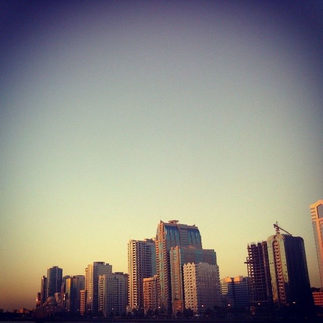 SKYSCRAPERS IN CITY AT SUNSET