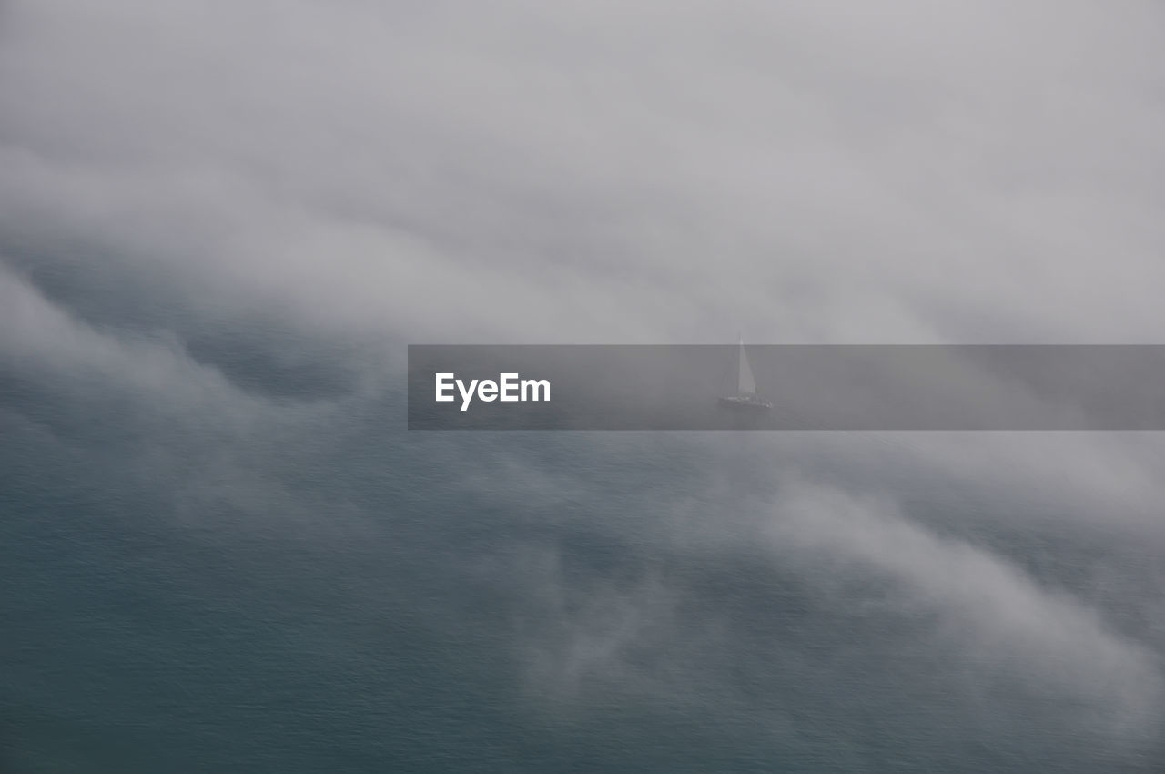 Low angle view of sailboat in sea against sky