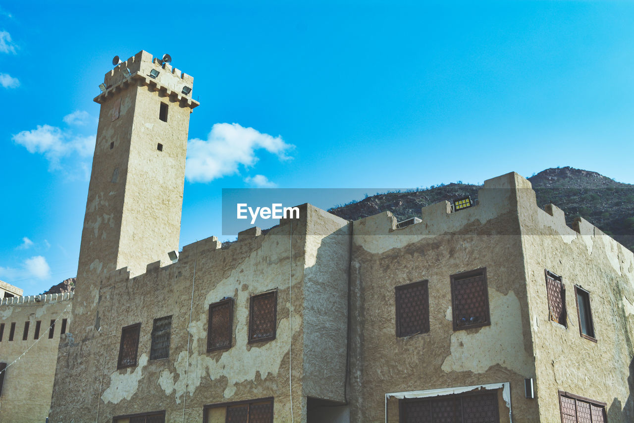 Low angle view of a historic building under a blue sky