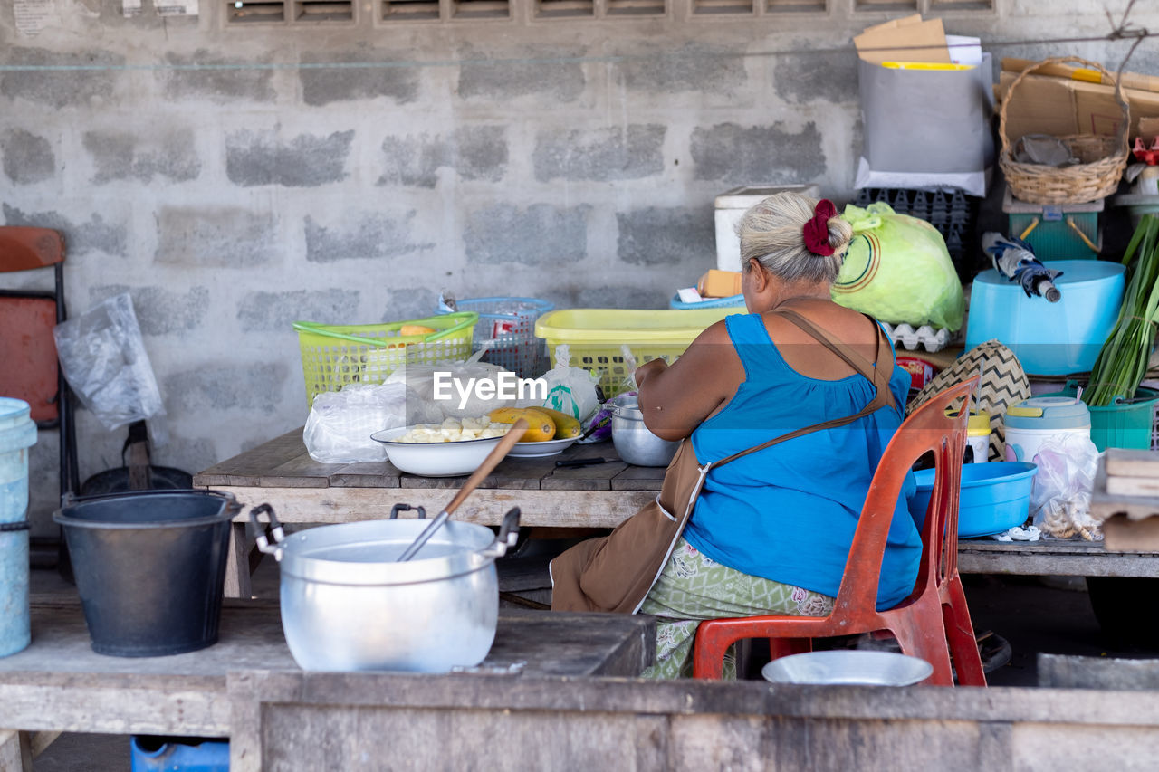 Rear view of woman preparing food in kitchen