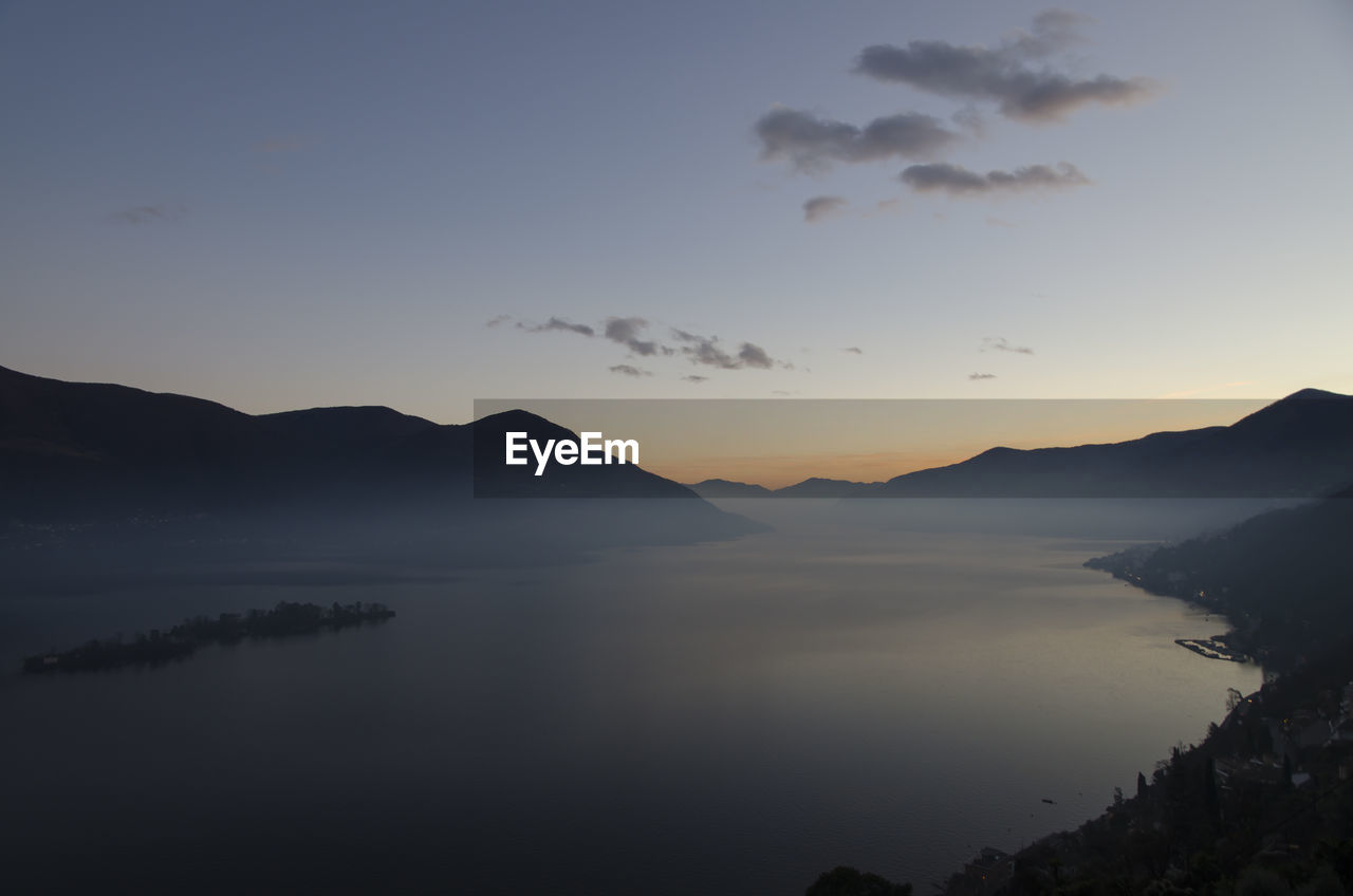 Scenic view of lake against sky during sunset