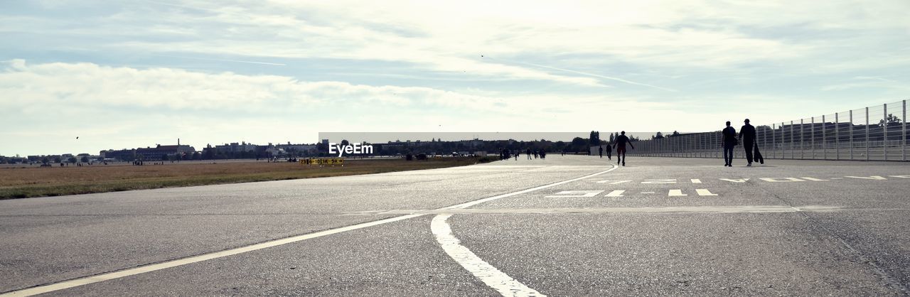 GROUP OF PEOPLE ON ROAD IN CITY