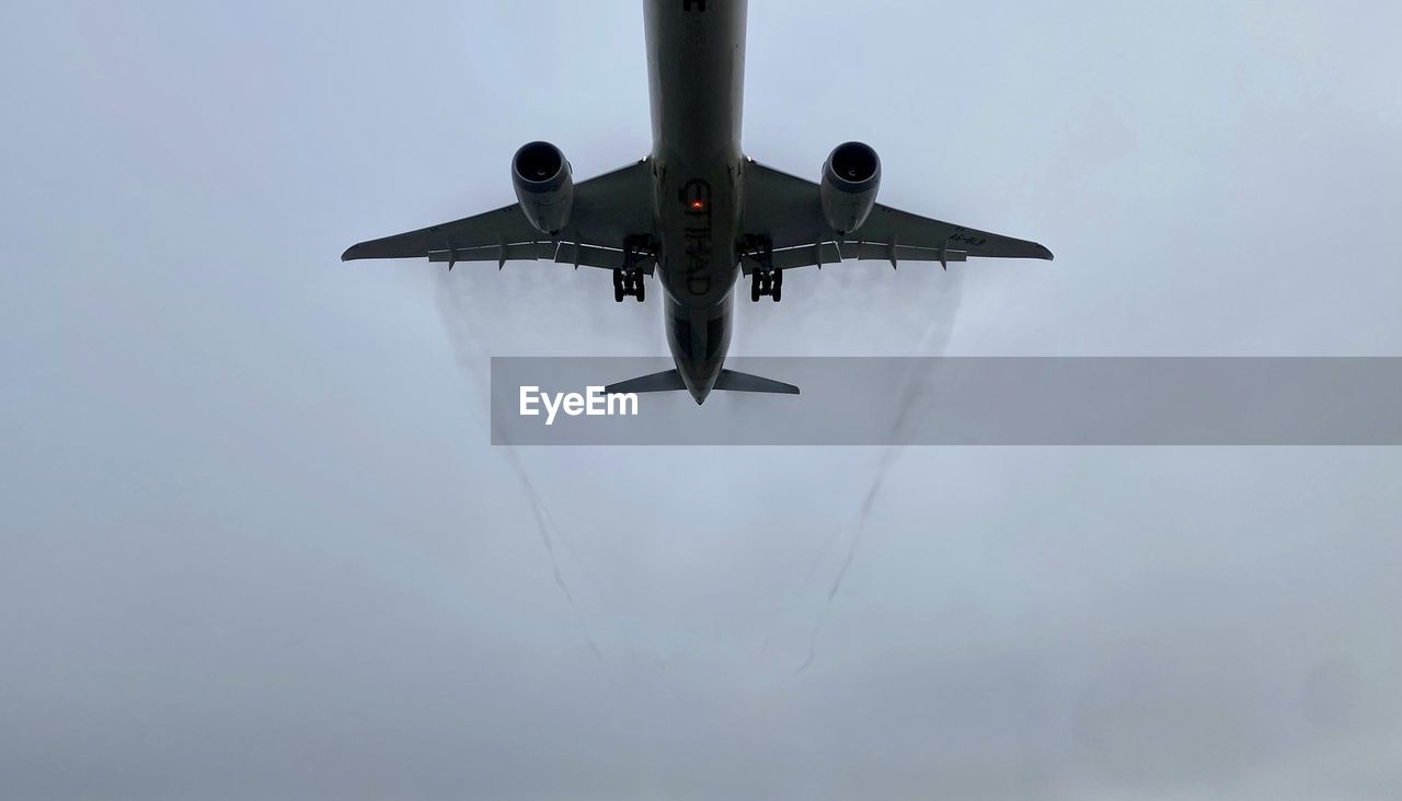 LOW ANGLE VIEW OF AIRPLANE FLYING IN SKY