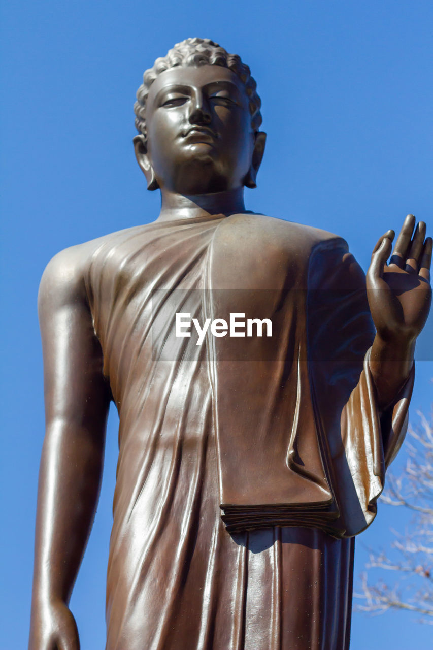 statue, sculpture, monument, blue, human representation, clear sky, sky, architecture, religion, low angle view, male likeness, belief, bronze sculpture, spirituality, nature, representation, no people, art, day, craft, outdoors, classical sculpture