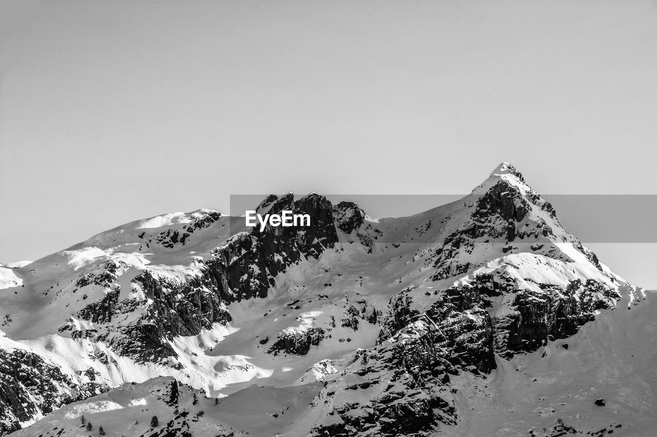 Scenic view of snowcapped mountains against clear sky